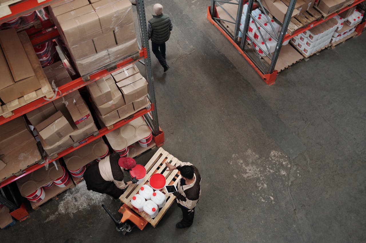 High angle view of warehouse workers handling inventory and logistics operations.